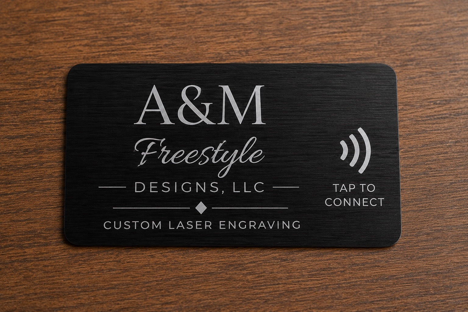 Front of custom engraved black stainless steel NFC QR card with A&M Freestyle Designs logo